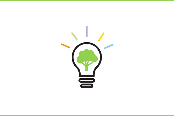 A lightbulb with a green tree inside and colorful lines radiating symbolizes eco-friendly innovation.