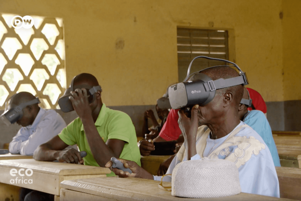 Men in a classroom engage with virtual reality headsets for an immersive learning experience.