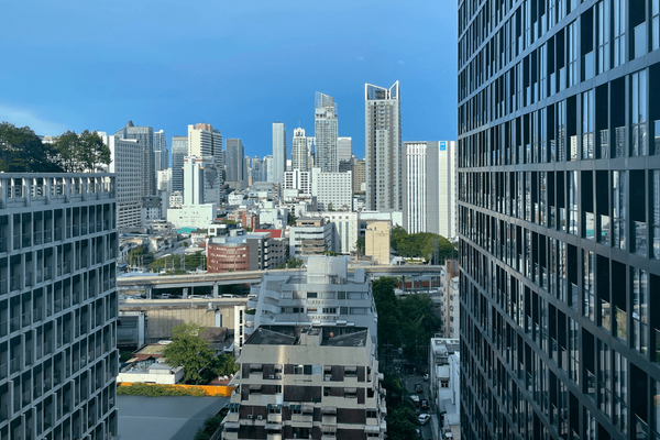 A vibrant city skyline with modern skyscrapers under a clear blue sky.